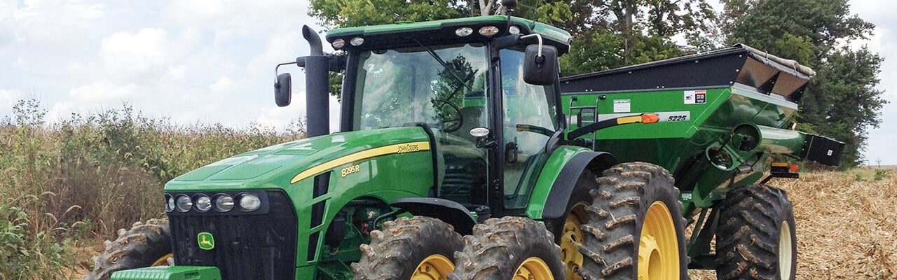 used John Deere 8295R tractor with Brent grain cart
